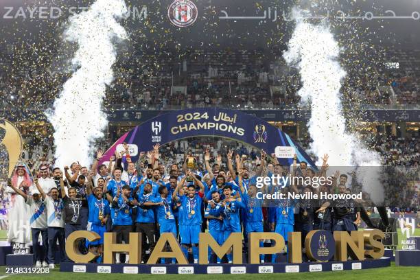Al Hilal players lift the Saudi Super Cup after defeating Al Ittihad during the Saudi Super Cup Final between Al Ittihad and Al Hilal at the Mohammed...