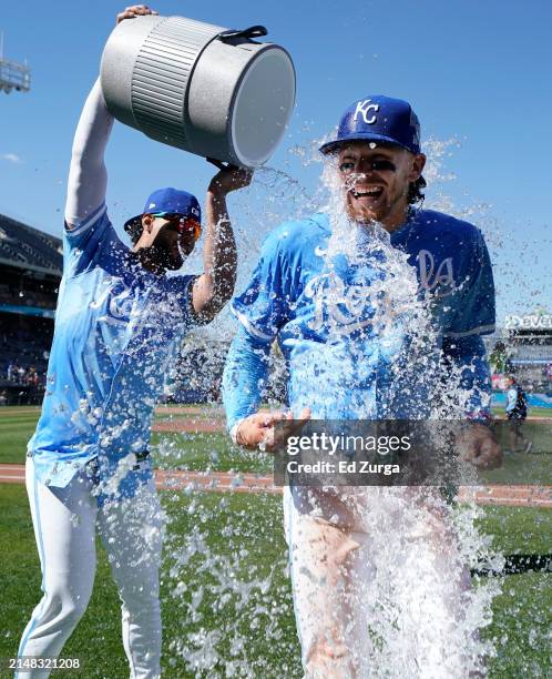 Bobby Witt Jr. #7 of the Kansas City Royals is doused with water by MJ Melendez of the Kansas City Royals after a 13-3 win over the Houston Astros at...