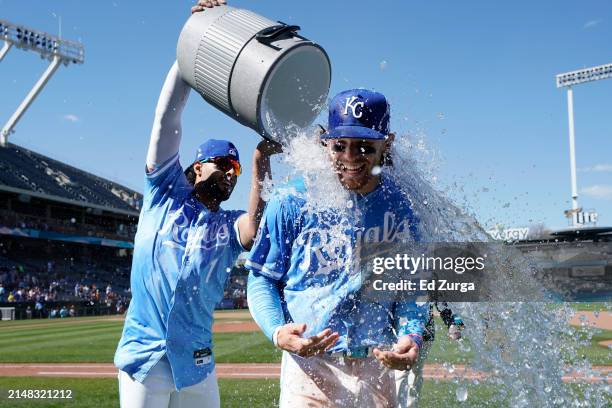 Bobby Witt Jr. #7 of the Kansas City Royals is doused with water by MJ Melendez of the Kansas City Royals after a 13-3 win over the Houston Astros at...