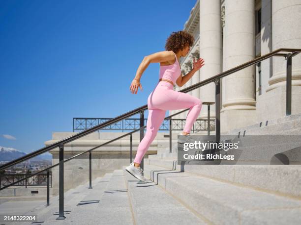 woman running up steps - government building steps stock pictures, royalty-free photos & images