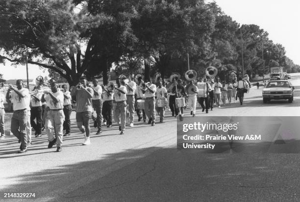 Prairie View A&M University's marching band playing musical instrument on street during an event in Texas.