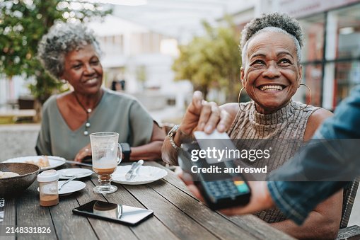 Senior woman making credit card payment Senior woman making credit card payment