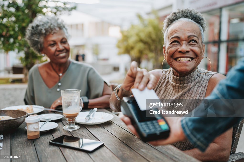 Senior woman making credit card payment