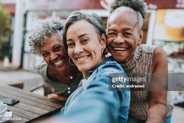 portrait group of friends taking selfie - senior selfie stock pictures, royalty-free photos & images