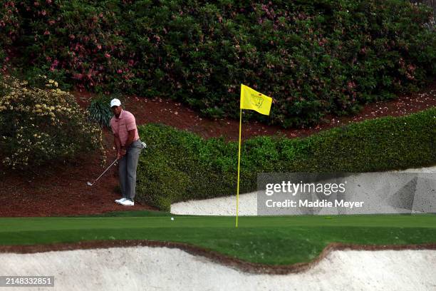 Tiger Woods of the United States plays a shot on the 12th hole during the first round of the 2024 Masters Tournament at Augusta National Golf Club on...