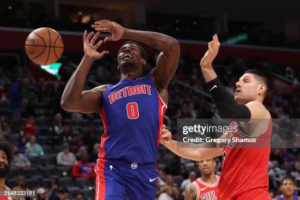 Nikola Vucevic of the Chicago Bulls fouls Jalen Duren of the Detroit Pistons on his way to the basket during the first half at Little Caesars Arena...