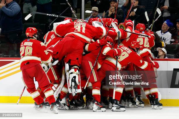 Members of the Denver Pioneers celebrate their victory against the Boston University Terriers after the NCAA Men's Hockey Frozen Four semifinal game...