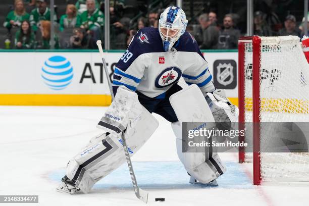 Laurent Brossoit of the Winnipeg Jets plays the puck at his net during the first period against the Dallas Stars at American Airlines Center on April...