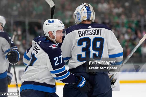 Nikolaj Ehlers of the Winnipeg Jets celebrates with Laurent Brossoit after scoring a goal during the first period against the Dallas Stars at...