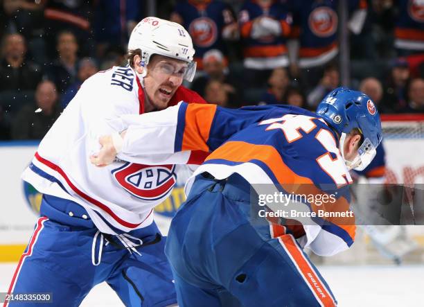 Brendan Gallagher of the Montreal Canadiens and Jean-Gabriel Pageau of the New York Islanders fight during the second period at UBS Arena on April...