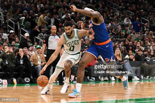 Jayson Tatum of the Boston Celtics drives to the basket against Mitchell Robinson of the New York Knicks during the third quarter at the TD Garden on...