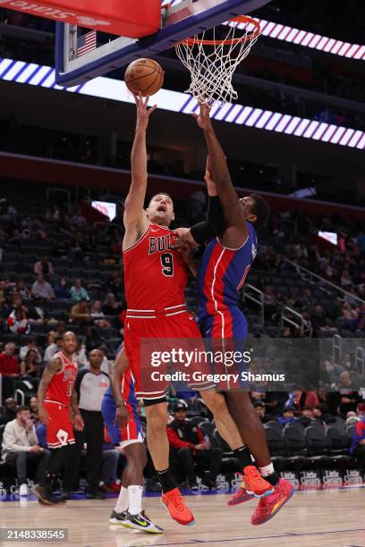 Nikola Vucevic of the Chicago Bulls drives to the basket against Jalen Duren of the Detroit Pistons during the second half at Little Caesars Arena on...