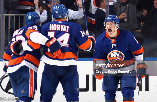 Mathew Barzal of the New York Islanders celebrates a third period goal by Casey Cizikas against the Montreal Canadiens at UBS Arena on April 11, 2024...