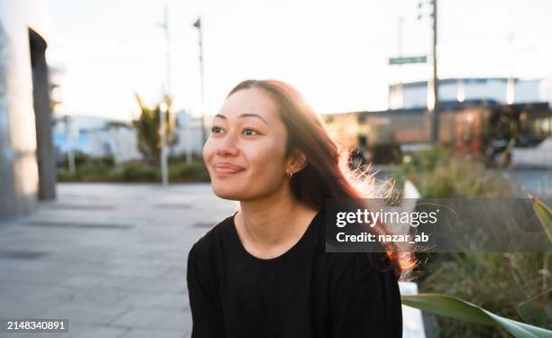 thoughtful woman with smile on her face. - new zealand people stock pictures, royalty-free photos & images