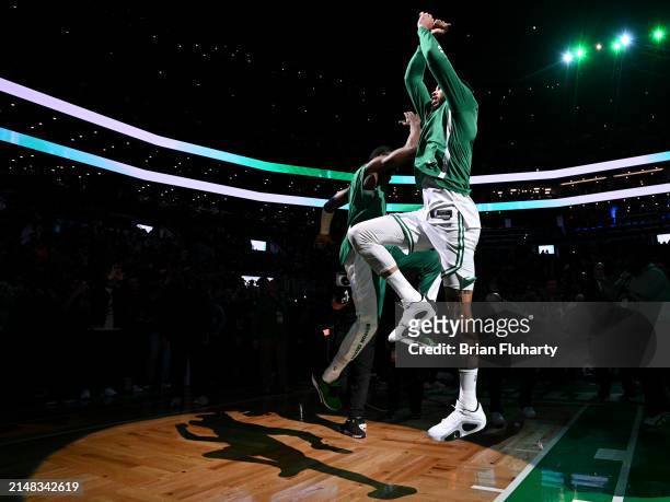 Jayson Tatum of the Boston Celtics high-fives Jaylen Brown before a game against the New York Knicks at the TD Garden on April 11, 2024 in Boston,...