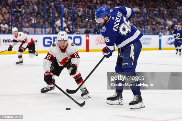 Nikita Kucherov of the Tampa Bay Lightning against Erik Brannstrom of the Ottawa Senators during the third period at Amalie Arena on April 11, 2024...