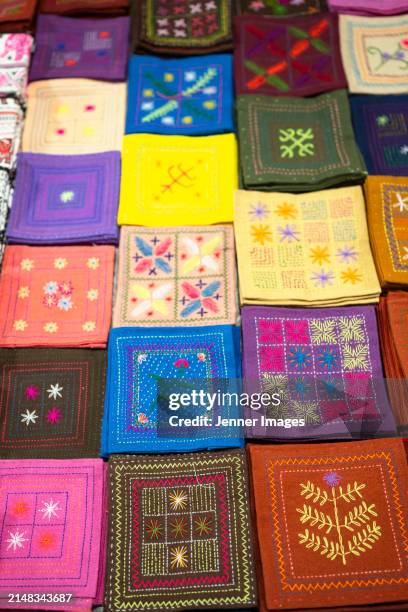 textile souvenir's for sale at luang prabang night market on sisavangvong road. - jenner stock pictures, royalty-free photos & images