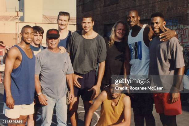 Shaquille O'Neal, second from right, smiles for a photograph surrounded by cast and crew on the set of a Pepsi "Shaq Attack" commercial wearing a...