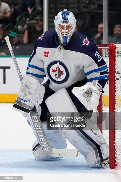 Laurent Brossoit of the Winnipeg Jets defends his net during the third period against the Dallas Stars at American Airlines Center on April 11, 2024...