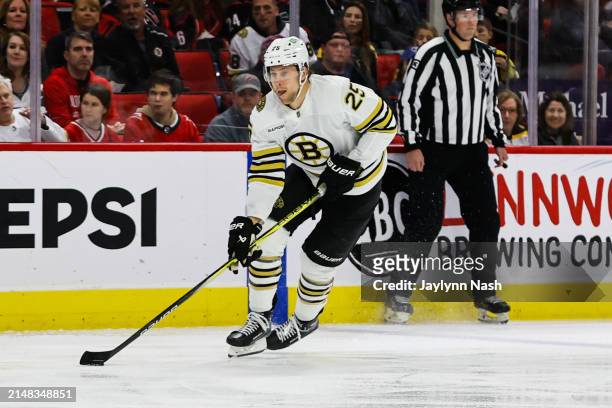 Brandon Carlo of the Boston Bruins skates with the puck during the first period of the game against the Carolina Hurricanes at PNC Arena on April 04,...
