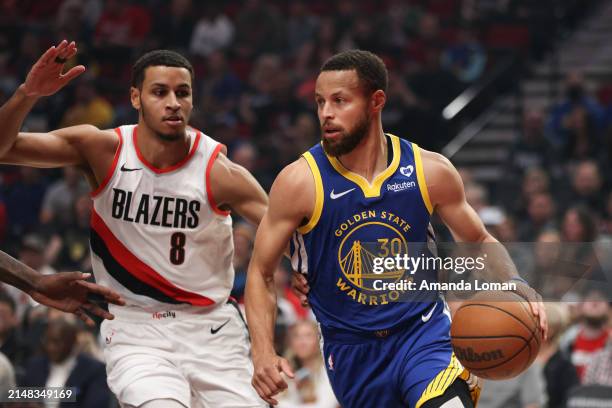 Stephen Curry of the Golden State Warriors drives against Kris Murray of the Portland Trail Blazers during the first quarter at Moda Center on April...