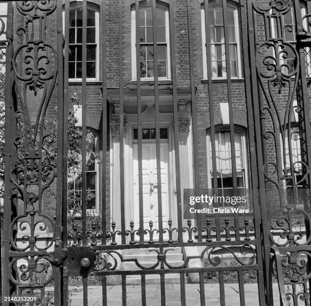 Exterior view through the wrought iron gate of 4 Cheyne Walk, the former home of Irish artist Daniel Maclise, in Chelsea, West London, England, 1949.