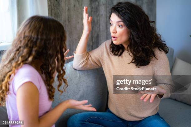 woman argues with her teenage daughter - ilska bildbanksfoton och bilder
