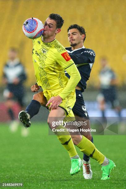 Bozhidar Kraev of the Phoenix is challenged by Fabian Monge of the Victory during the A-League Men round 24 match between Wellington Phoenix and...