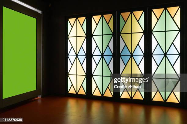 electronic advertising screen next to the stained glass door - stained glass door stock pictures, royalty-free photos & images