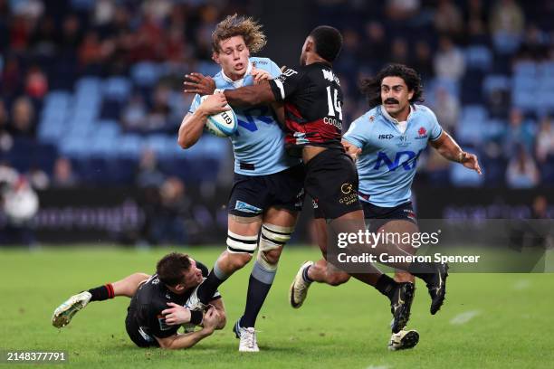 Ned Hanigan of the NSW Waratahs is tackled by Dallas McLeod of the Crusaders and Sevu Reece of the Crusaders during the round eight Super Rugby...