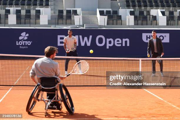 Nico Langmann of Austria plays the ball with Felix Auger-Aliassime of Canada and Mischa Zverev after the opening press conference for the BMW Open at...