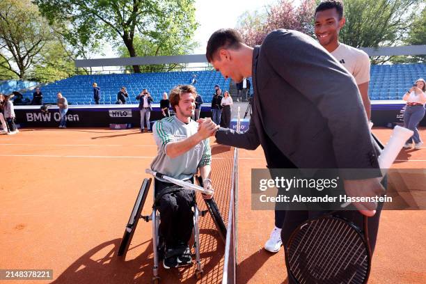 Nico Langmann of Austria shake hands with Felix Auger-Aliassime of Canada and Mischa Zverev after the opening press conference for the BMW Open at...