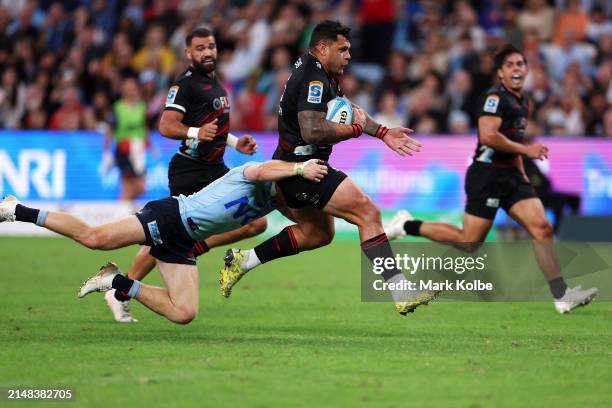 Levi Aumua of the Crusaders is tackled during the round eight Super Rugby Pacific match between NSW Waratahs and Crusaders at Allianz Stadium, on...