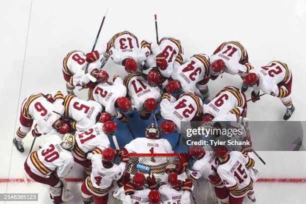 The Boston College Eagles huddle around Jacob Fowler before the game against the Michigan Wolverines during the Division I Mens Ice Hockey Semifinals...