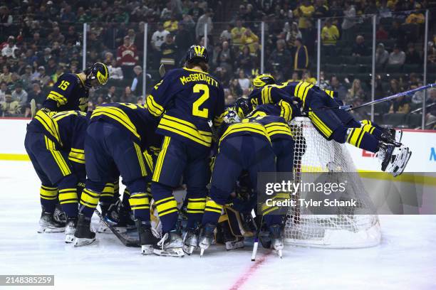 The Michigan Wolverines huddle before the game against the Boston College Eagles during the Division I Mens Ice Hockey Semifinals held at Xcel Energy...