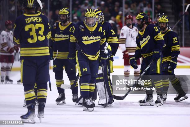 Marshall Warren of the Michigan Wolverines laughs with teammates between plays in the second period of the game against the Boston College Eagles in...