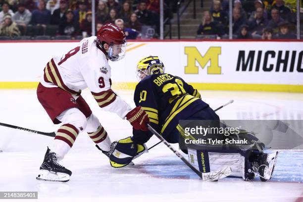 Jake Barczewski of the Michigan Wolverines makes a save Ryan Leonard of the Boston College Eagles in the third period during the Division I Mens Ice...