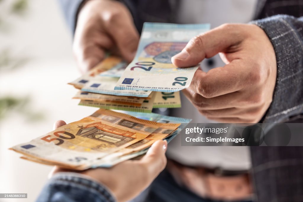 Businessman's hands exchanging euro, closeup shot.