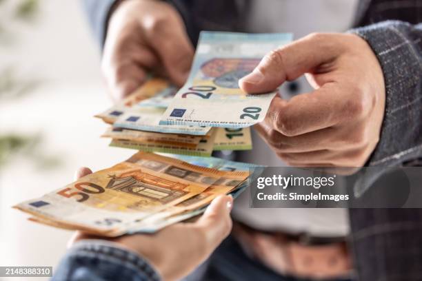 businessman's hands exchanging euro, closeup shot. - bonus pay stock pictures, royalty-free photos & images