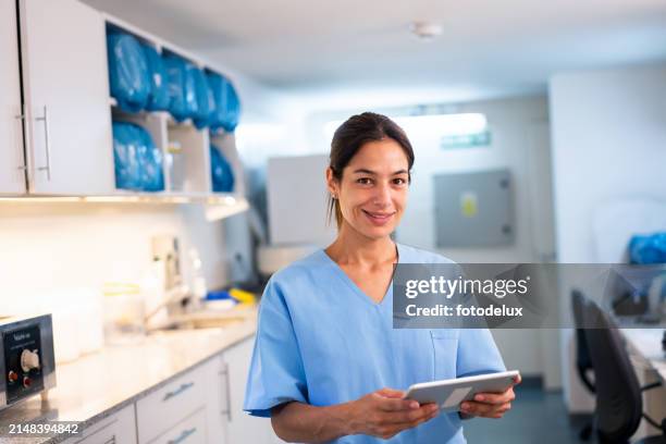 confident female nurse holding tablet in hospital - electronic medical record stock pictures, royalty-free photos & images