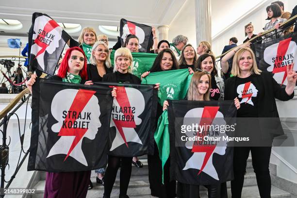 Pro abortion activists hold the All Women's strike flag as they celebrate after watching the voting on four draft projects on abortion rights on...