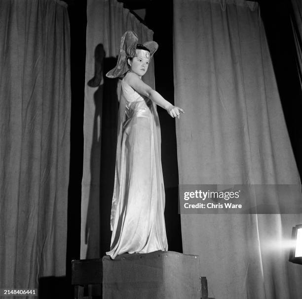 Schoolgirl Shani Wallis as the Archangel Gabriel points as she delivers the line, 'Let us make man in our own image' during the opening of a...