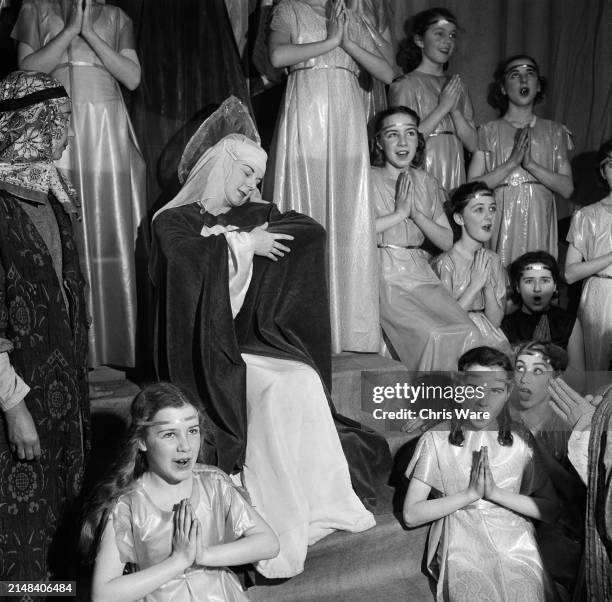 Schoolgirl Christine Statham plays the Virgin Mary surrounded by angels during the finale of the Nativity at Tottenham High School for Girls in...