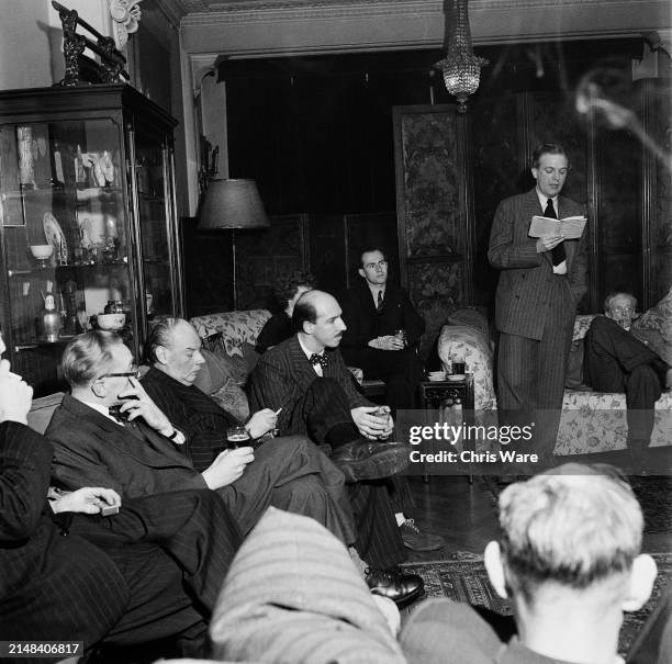 British poet and journalist John Waller stands as he recites one of his poems during a meeting of the Poetry Forum, at a Marlborough Place property...