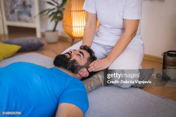 man having head massage for headache - man head massage stock pictures, royalty-free photos & images