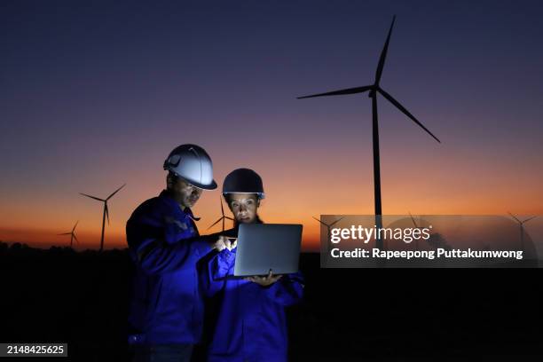 alternative energy concepts. maintenance engineers supervising the condition of the power equipment in a wind turbines power station with digital tablet. teamwork. - essential services stock pictures, royalty-free photos & images