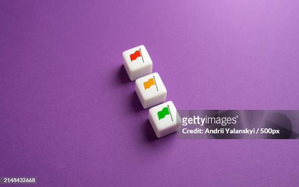high angle view of dice on purple background - societal conflict fotografías e imágenes de stock