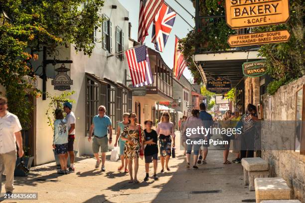 st. augustine florida people walk along saint george street in the historic district - st augustine florida stock pictures, royalty-free photos & images