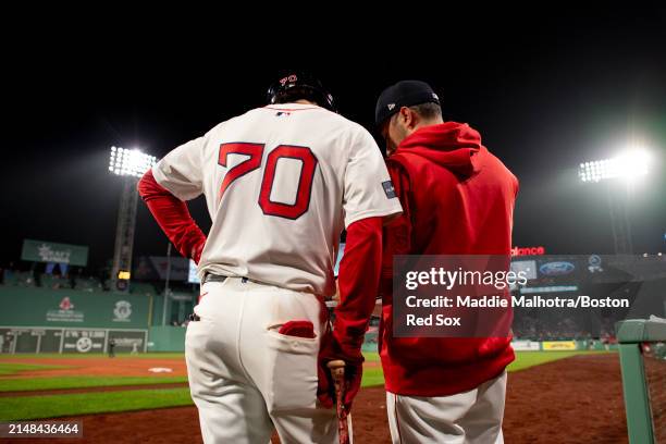 David Hamilton of the Boston Red Sox talks with Hitting Coach Pete Fatse during a game against the Baltimore Orioles on April 11, 2024 at Fenway Park...