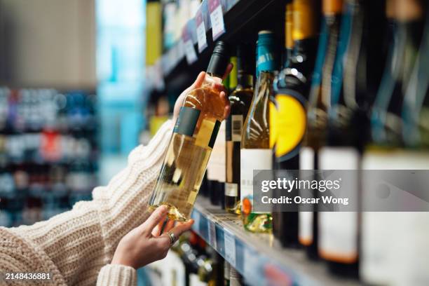 young asian woman shopping wine in supermarket - bottle stock pictures, royalty-free photos & images